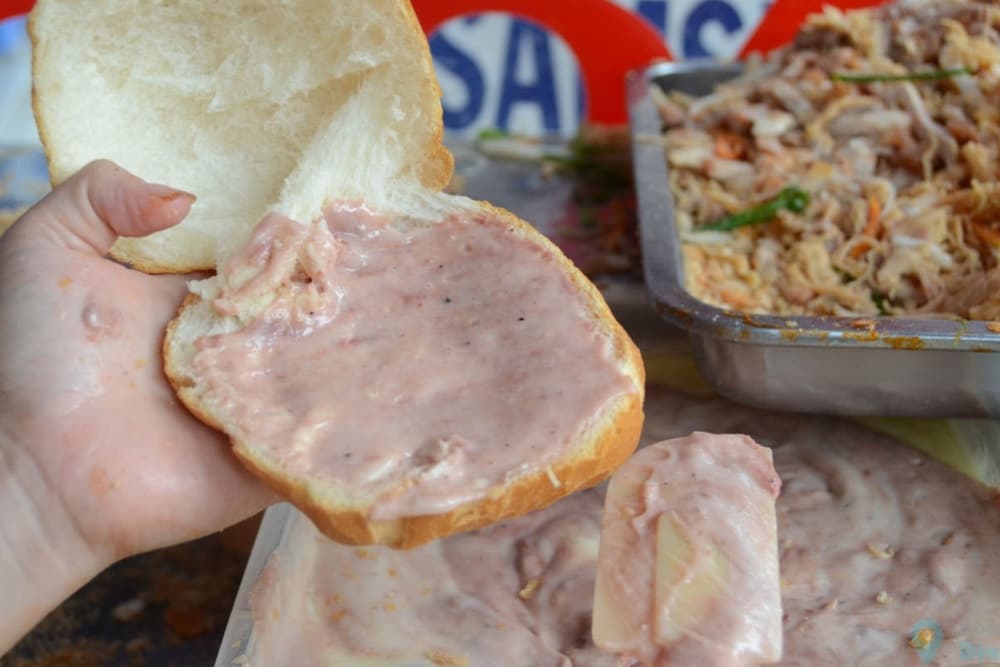 Butter and pâté are mixed together into a rich, creamy sauce, generously spread over the banh mi for an irresistible flavor